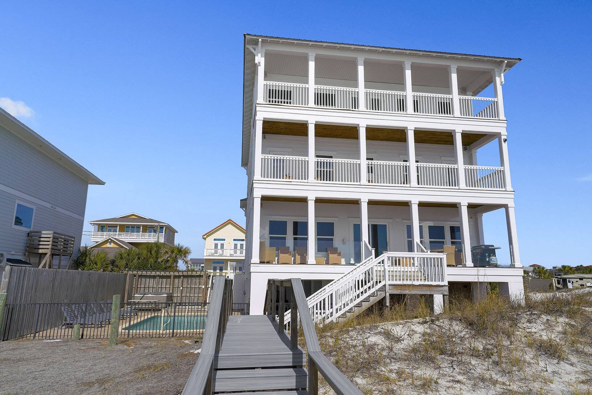 Aerial view of the gulf-front house and pool